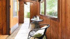 A wooden interior with a covered patio, a table, and chairs. - 4 Person Holiday Home in Brastad-by Traum (Brastad)