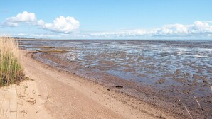 A beach with a sandy shore, a dirt path, and a distant view of the sea. - 4 Person Holiday Home in Romo (Rømø)