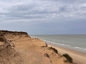 A coastal landscape with a sandy beach and dunes. - Picturesque Holiday Home in LÃ¸kken near Sea (Lokken)