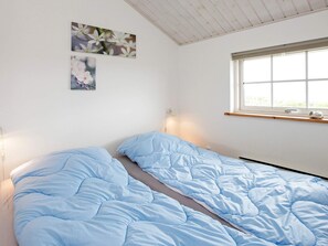 A room with a bed, a window, and wall art. - Picturesque Holiday Home in LÃ¸kken near Sea (Lokken)