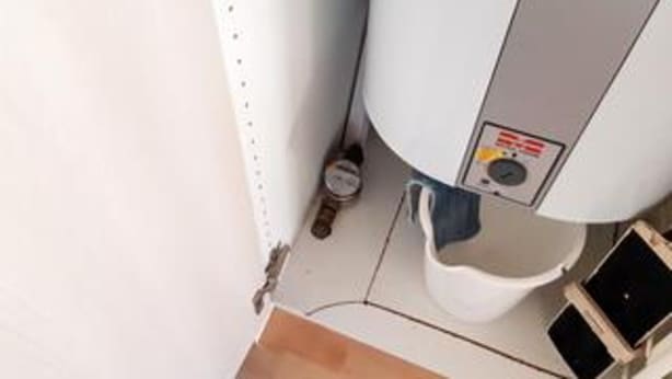 A bathroom with a toilet, bidet, and a control panel with a warning label. - 5 Star Holiday Home in Juelsminde (Horsens)