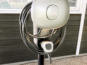 A parking meter with a keypad and a coin slot, mounted on a pole.