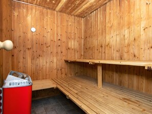 A sauna with wooden walls and benches. - 4 Star Holiday Home in Henne (Henne)