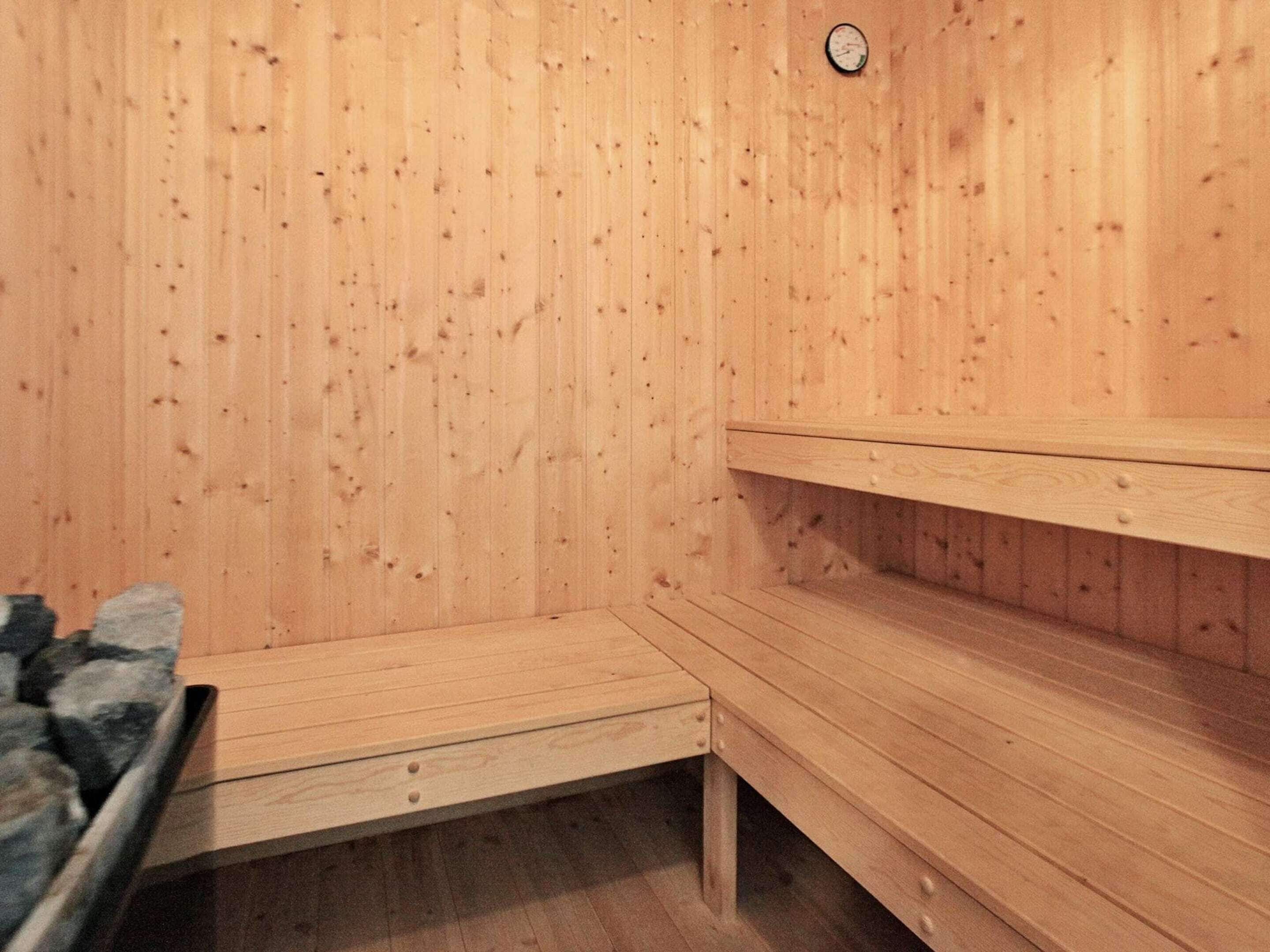 A sauna room with wooden walls and benches.