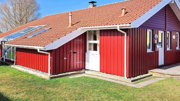 A red building with a sloped roof, a door, and a window. - Holiday Home in Otterndorf (Otterndorf)