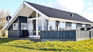 A modern house with a sloped roof, large windows, and a covered porch. - Lovely Holiday Home in Lemvig near Sea (Lemvig)
