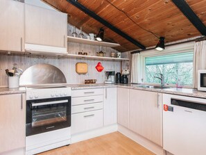 A modern kitchen with white cabinets, a stainless steel oven, and a built-in microwave. - Superb Holiday Home in Hemmet near Sea (Hemmet)