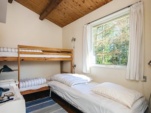 A room with bunk beds, a desk, and a window with curtains. - 5 Person Holiday Home in Hojslev (Hojslev)