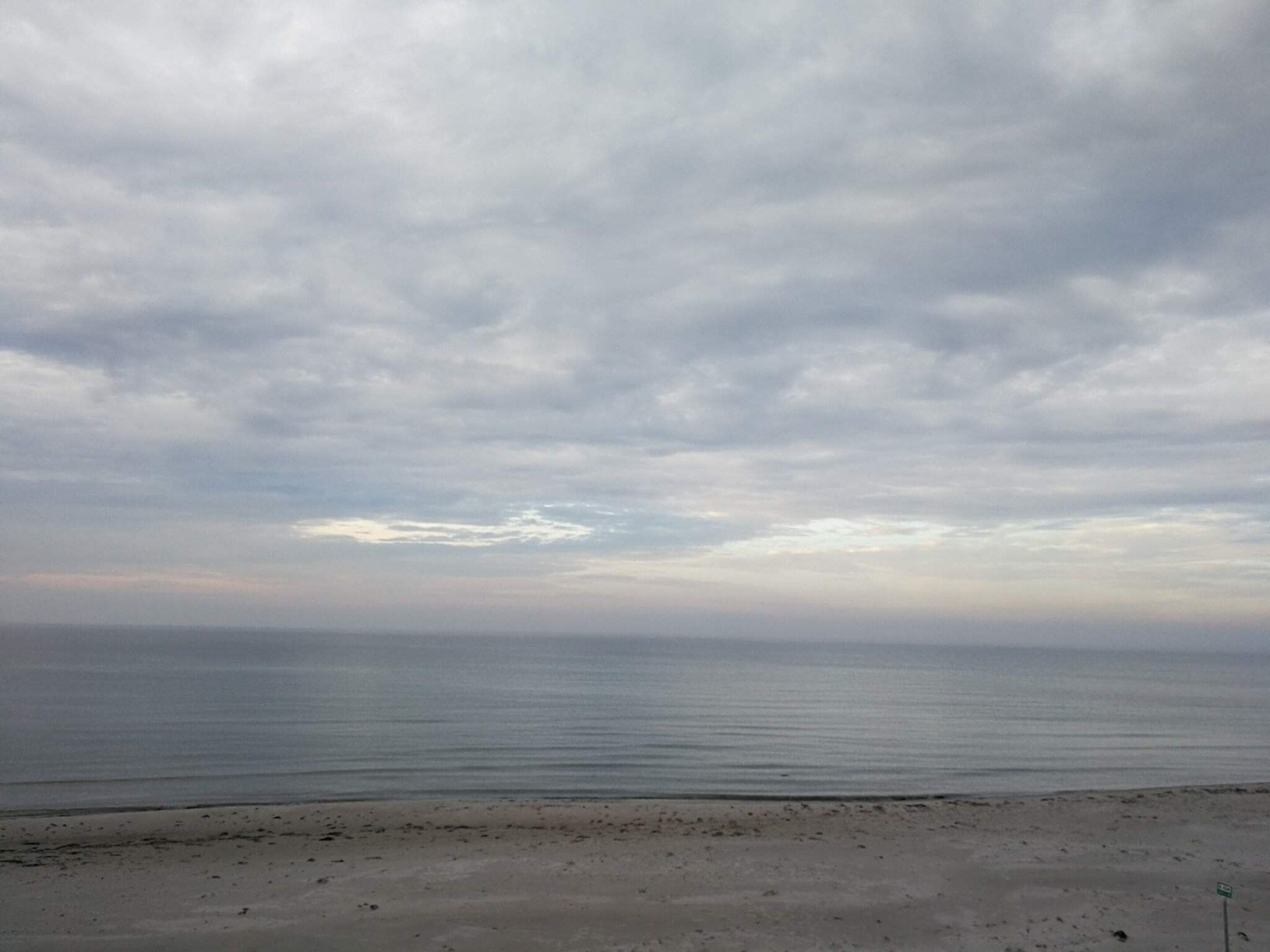A beach with a cloudy sky.