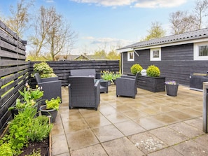 A patio with outdoor furniture and planters. - 4 Star Holiday Home in Hemmet (Hemmet)