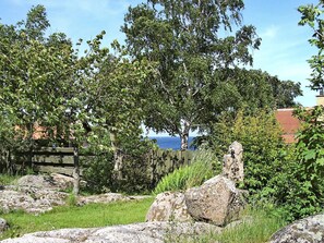 A natural landscape with trees, rocks, and a wooden fence. - Spacious Holiday Home in Allinge Bornholm near Sea (Allinge)