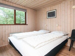 A room with two beds, a window, and a picture on the wall. - 4 Star Holiday Home in Hemmet (Hemmet)