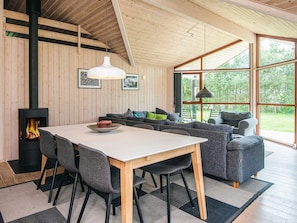 A modern interior with a dining area, sofa, and a fireplace. - 4 Star Holiday Home in Hemmet (Hemmet)