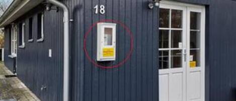 A building with a number 18 sign, a door, and a window.