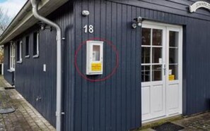 A building with a number 18 sign, a door, and a window. - 4 Star Holiday Home in Thyholm (Thyholm)