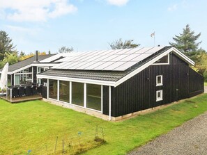 A modern house with a large glass extension, a sloped roof, and a number 31 sign. - 5 Star Holiday Home in Hjorring (Hjørring)