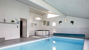 An indoor swimming pool with a clear view of the pool area, a seating area, and a reception desk. - 5 Star Holiday Home in Hjorring (Hjørring)