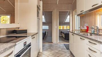A compact kitchen with a built-in oven, a sink, and a countertop.