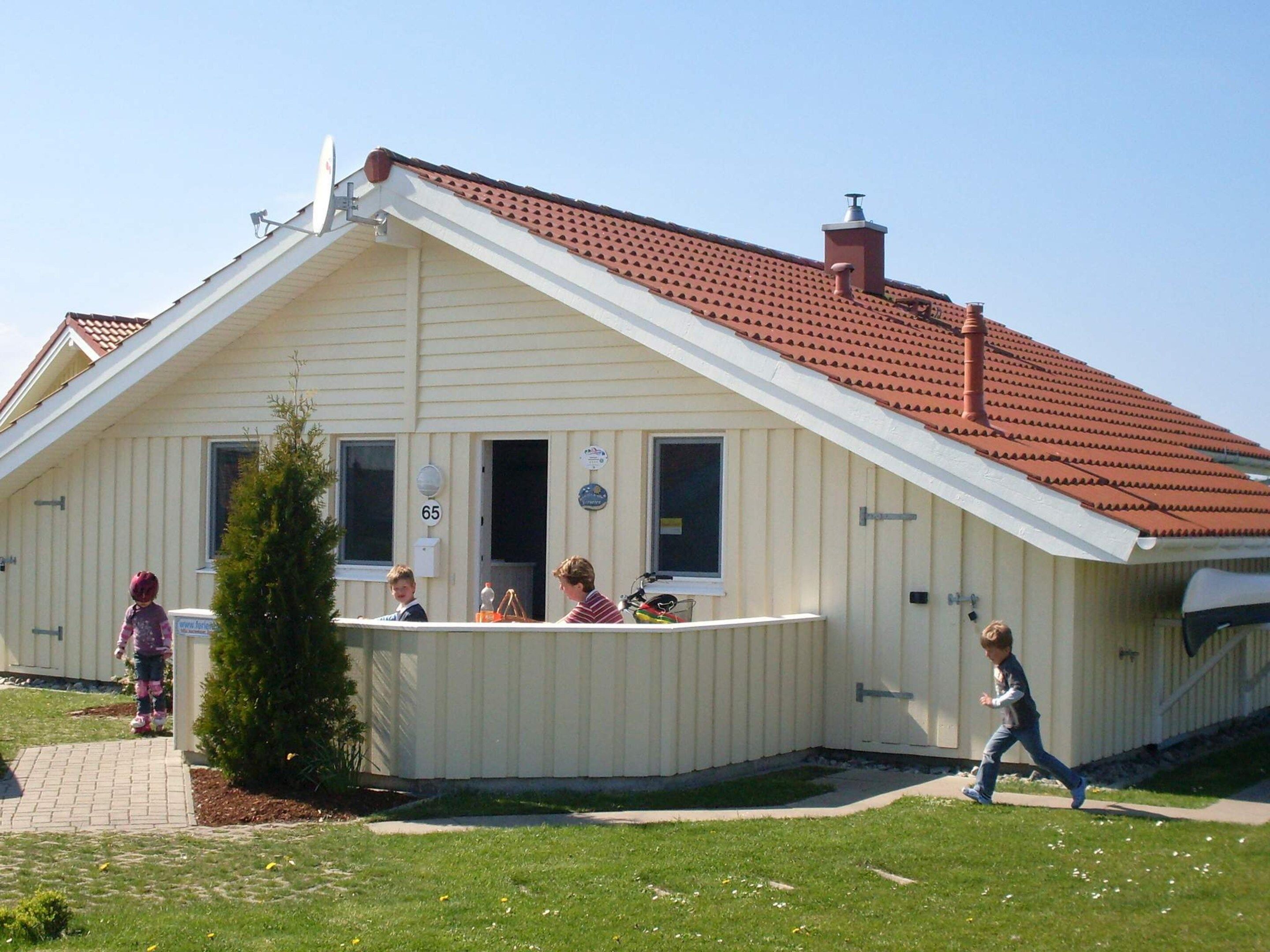 A building with a sloped roof, a small porch, and a mailbox.