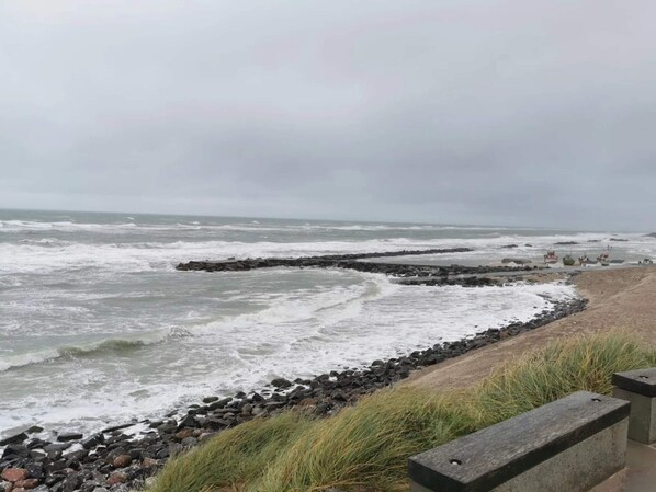 A rocky shoreline with waves crashing onto the rocks.