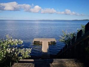 A wooden dock leading into calm blue water with a clear sky above. - 6 Person Holiday Home in Millinge (Millinge)