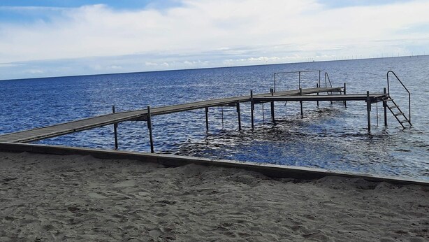 A wooden pier extending into calm blue waters, with a clear sky above. - 5 Star Holiday Home in Nysted (Nysted)