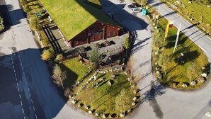 An aerial view of a building with a green roof, adjacent parking lot, and a road with traffic signs. - 27 Person Holiday Home in Dyrdal-by Traum (Gjesdal)