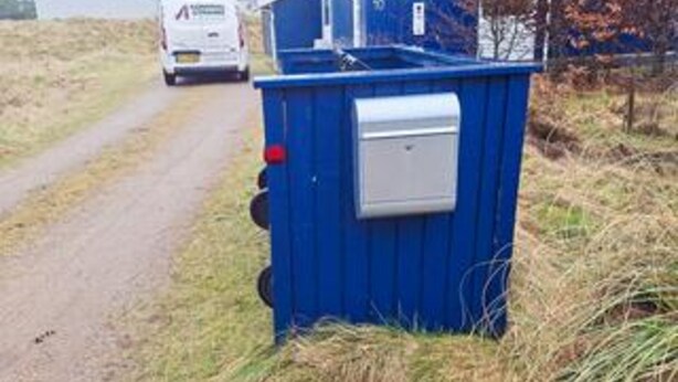 A blue portable toilet with a white lid, situated beside a road with a white vehicle in the background. - 4 Star Holiday Home in Fano (Fano)