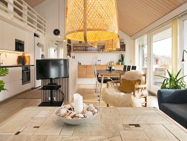 Enjoy a spacious open-plan living area with a kitchen and dining space, a comfortable seating area, and a large window for natural light.