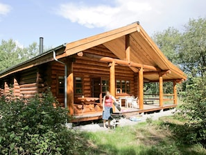 A log cabin with a porch, a grill, and a chimney. - 5 Star Holiday Home in Hadsund (Hadsund)