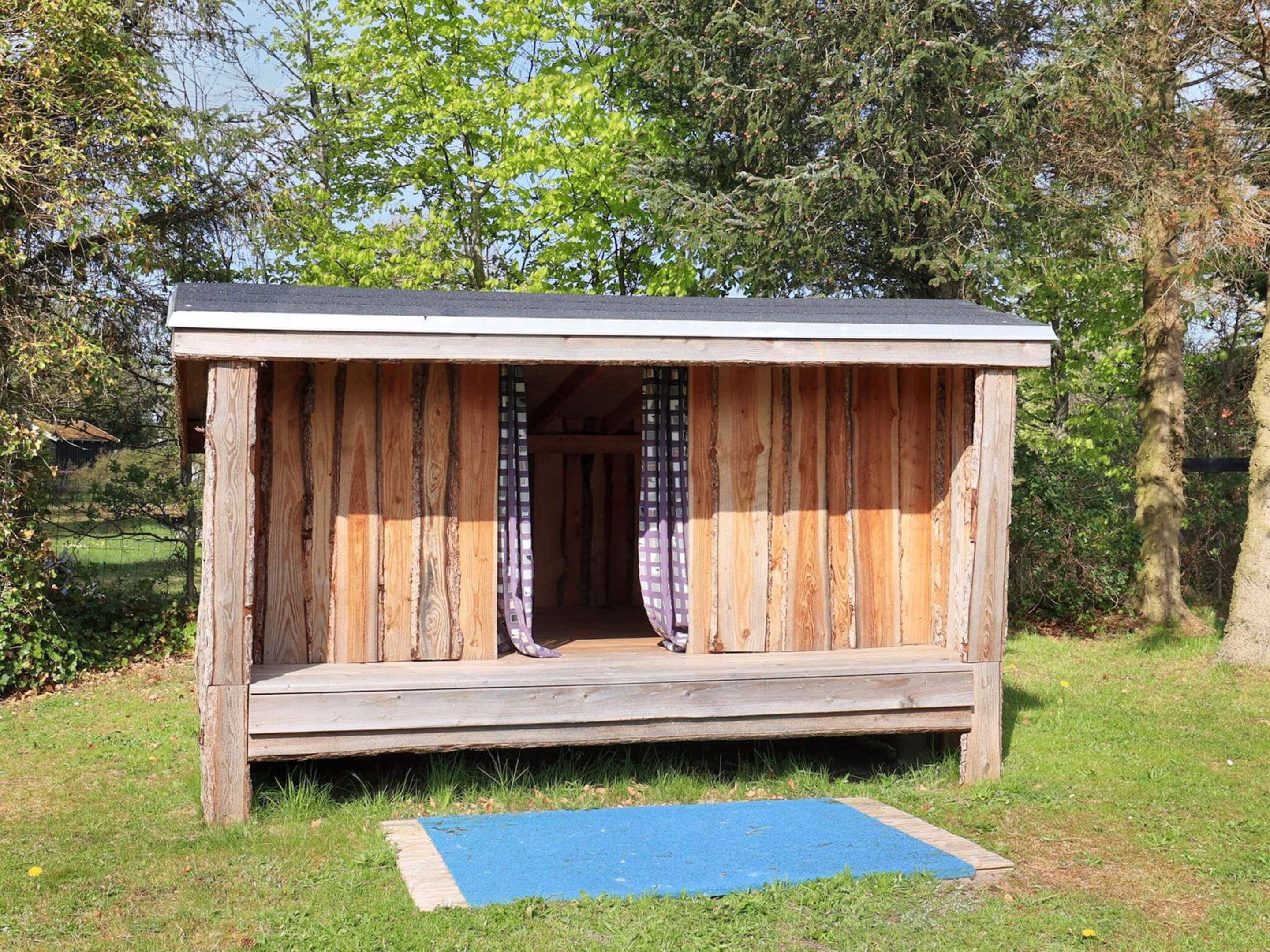 A wooden structure with a sloped roof and a small entrance.