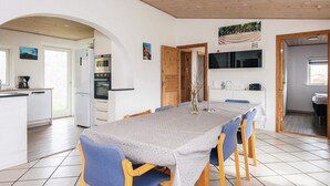 A modern kitchen with white cabinets, a built-in oven, and a microwave. - 4 Star Holiday Home in Juelsminde (Horsens)