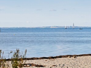 A calm sea with boats and a distant shoreline. - Holiday Home in Gilleleje (Gelting)