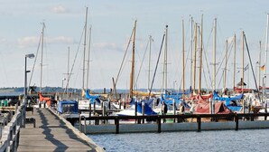 A wooden pier leading to a marina with multiple boats docked. - Holiday Home in Gilleleje (Gelting)