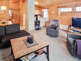 Una sala de estar acogedora con un sofá, sillones, una mesa de centro y una chimenea.