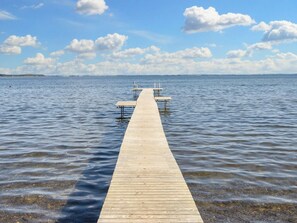 A wooden pier extending into calm water with a clear sky. - 4 Star Holiday Home in Sjolund (Sjølund)