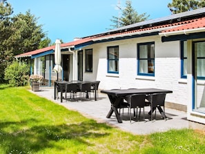 A building with a red roof, white exterior walls, and multiple windows. There is a patio with outdoor furniture. - 4 Star Holiday Home in Fjerritslev (Fjerritslev)