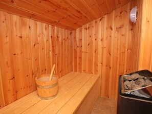 A sauna room with wooden walls and a wooden bench. - 8 Person Holiday Home in Lokken (Lokken)