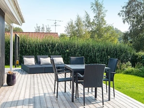 An outdoor patio with wicker furniture, a table, and a sofa. - 4 Star Holiday Home in Juelsminde (Horsens)