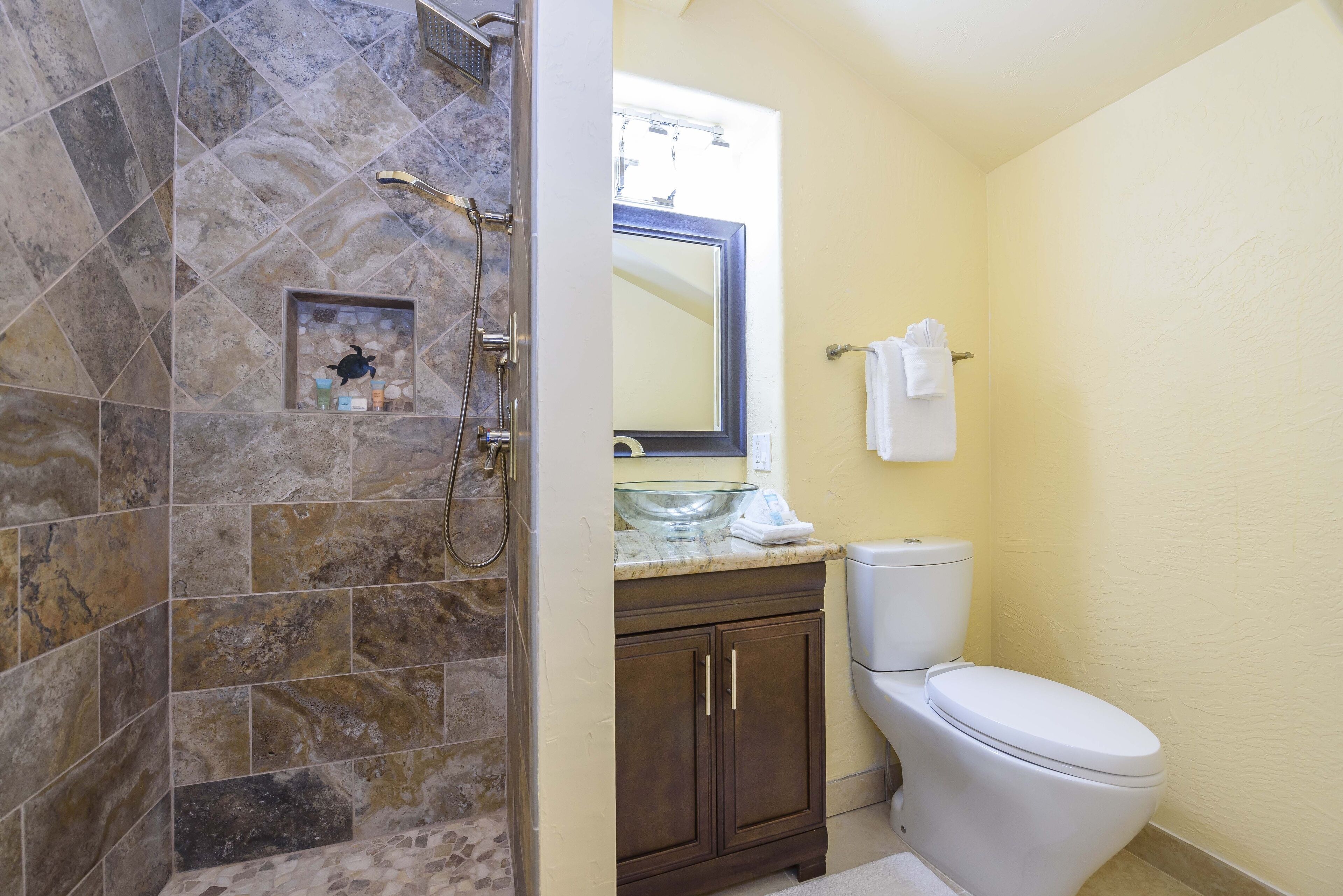 Un baño con ducha, inodoro y lavamanos.