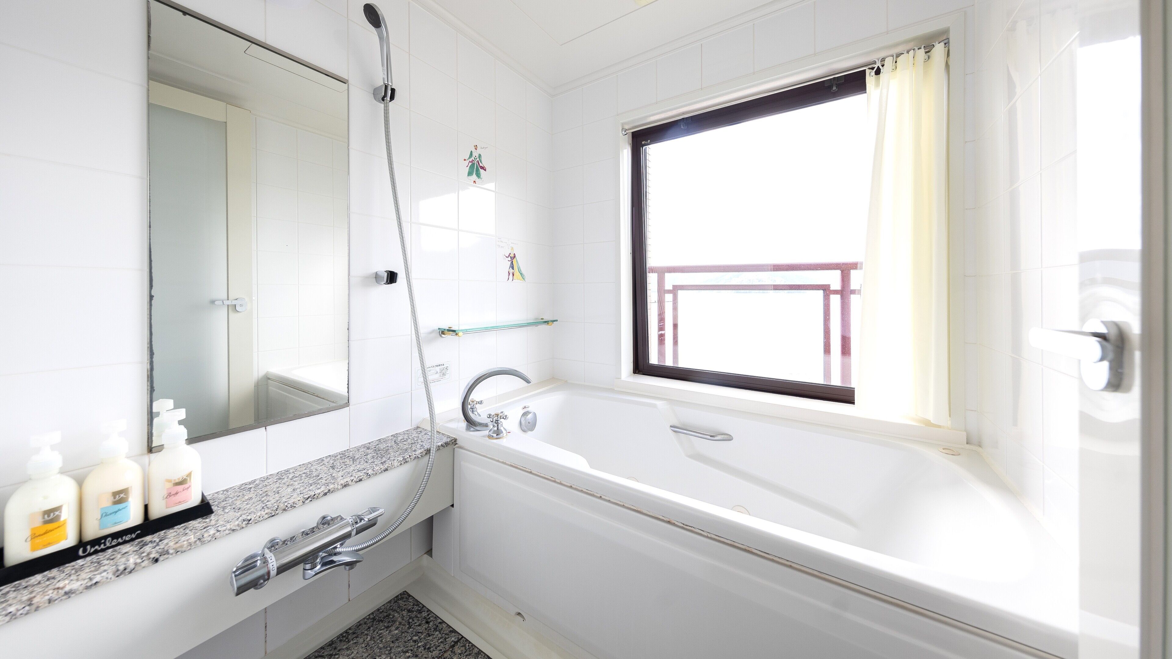 A modern bathroom with a large mirror, a shower, a bathtub, and a window with a view.