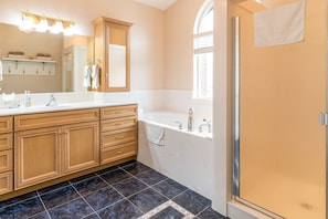 A modern bathroom with a large vanity, a bathtub, and a shower. - Family Crash Pad near SLC (Farmington)