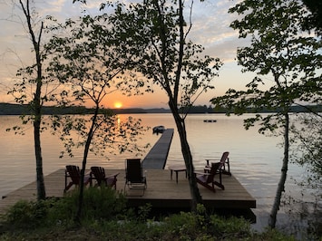 Gorgeous westward view of Peninsula Lake with large dock and a swimming raft. .