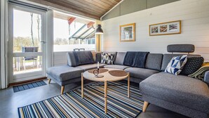 A modern living room with a grey sectional sofa, a round coffee table, and a striped rug. - Lovely home in Aabenraa with kitchen (Aabenraa)