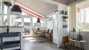 A modern kitchen with a dining area, large windows, and a view of the outdoors. - Lovely home in Aabenraa with kitchen (Aabenraa)