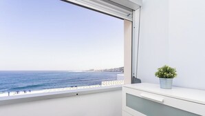 A balcony with a view of the sea and a white cabinet with drawers. - Home2Book Ocean View Bajamar Natural Pool & Beach (Bajamar)
