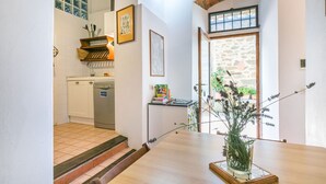 A kitchen with a dishwasher, a wooden shelf, and a window with a view of greenery. - Wonderful  villa for 8 people with WIFI, A/C, private pool, TV and patio (Greve In Chianti)