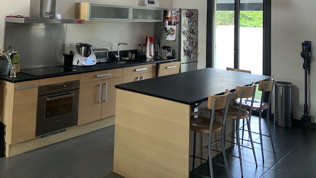 A modern kitchen with a central island, stainless steel appliances, and a large window. - Villa with pool, close to beaches and town center. (Narbonne)