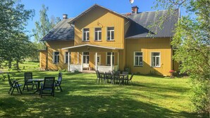 A two-story wooden house with a porch and outdoor seating area. - Stunning home in Värmlands Nysäter (Värmlands Nysäter)