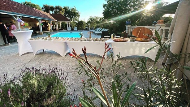 An outdoor pool area with a covered seating area and a table set for a meal. - 4★ group gîte, ideal for families and groups of friends (Villers-sur-Port)
